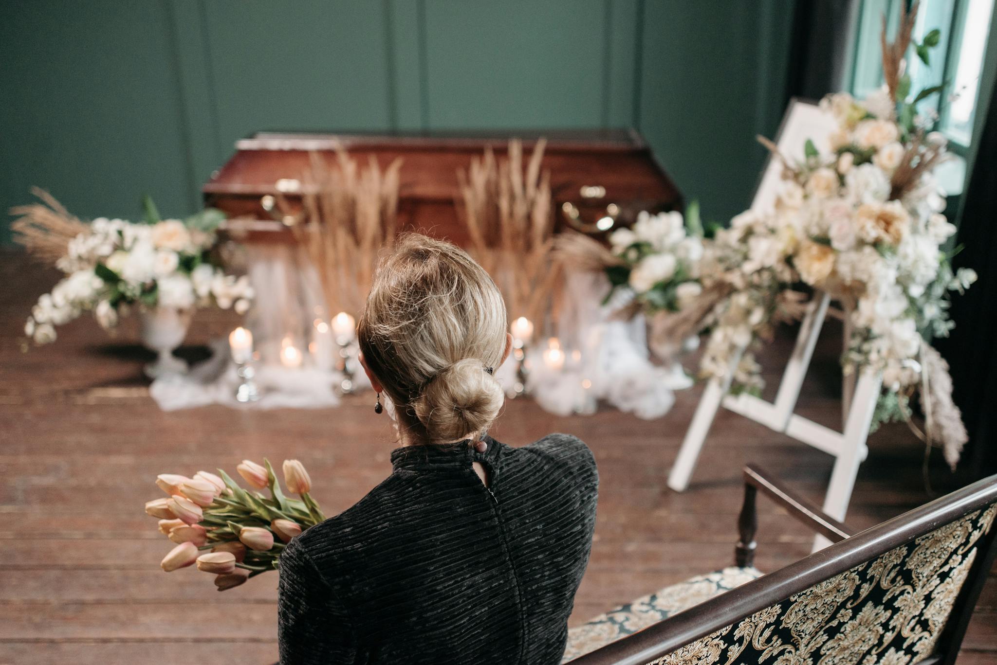 A Woman Mourns At An Indoor Funeral
